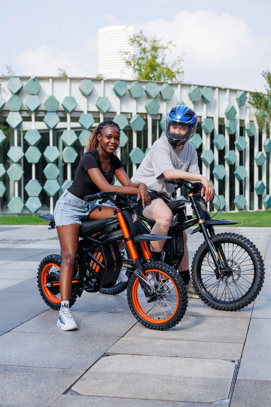 Two riders with Riding Times GT54 electric bikes, urban outdoor setting, modern design, one wearing helmet