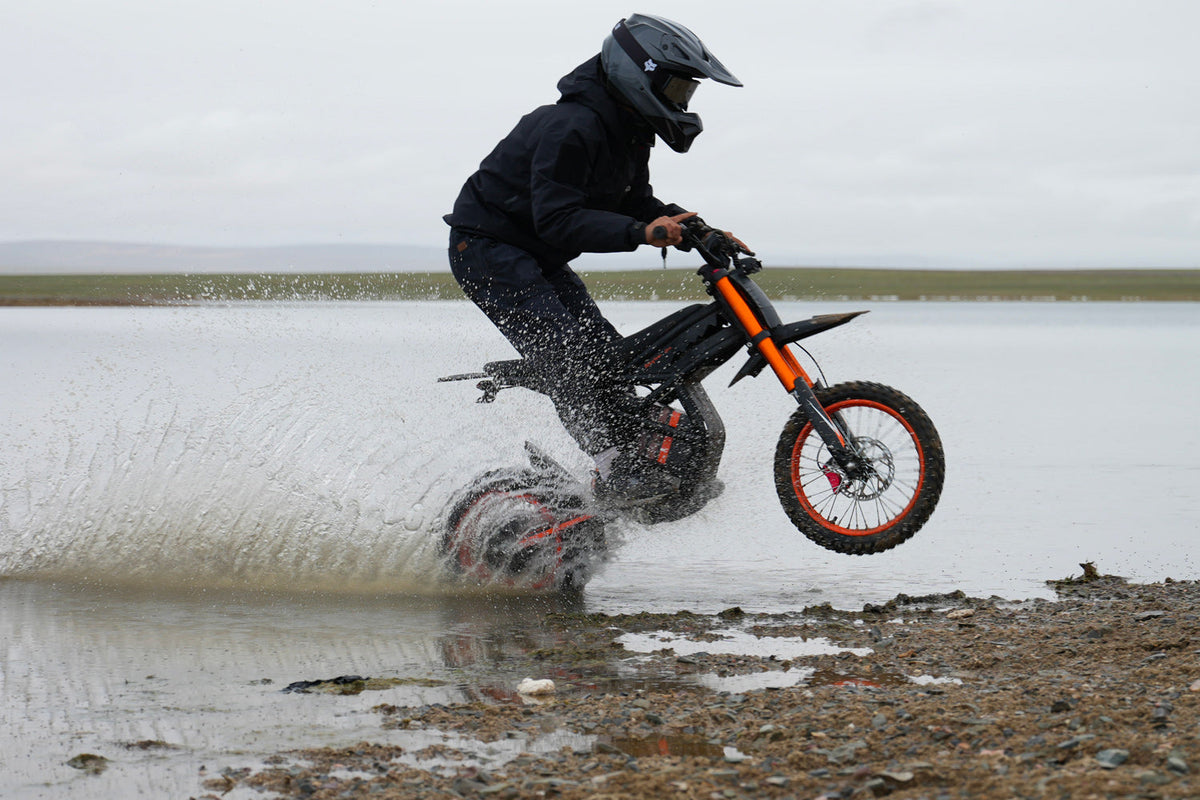GT54 platform reference riding through water on rocky terrain