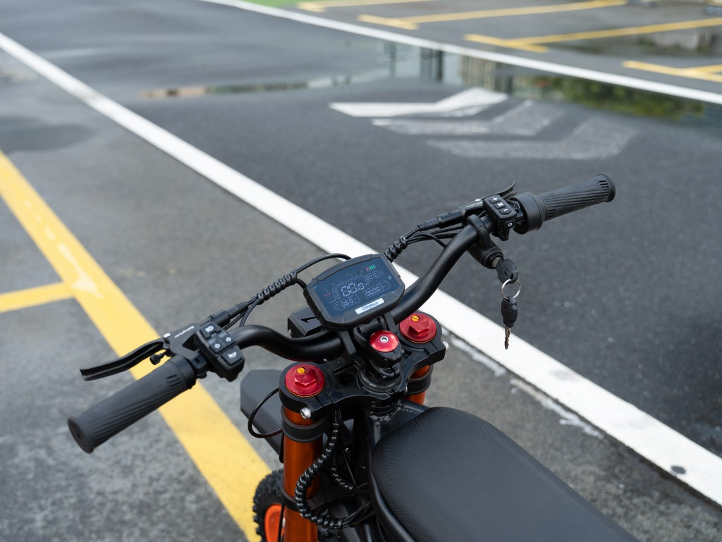GT54 electric mini motorbike handlebars with digital display and key in urban parking lot